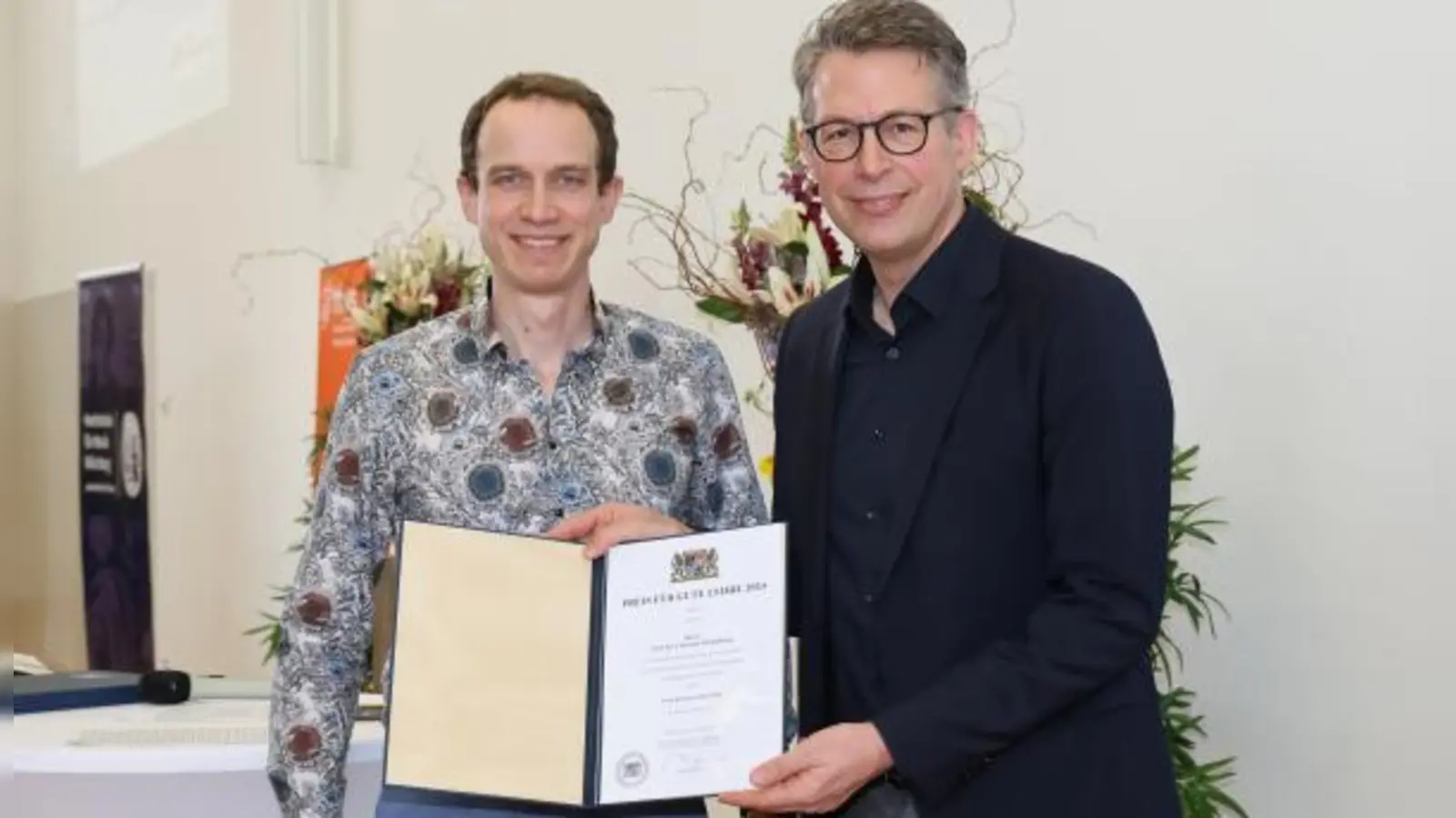 Am Montag überreichte Wissenschaftsminister Markus Blume (rechts) Prof. Dr. Christian Schmidkonz von der OTH Amberg-Weiden den Preis für gute Lehre. (Bild: Rudi Merkl / Bayerisches Staatsministerium für Wissenschaft und Kunst)