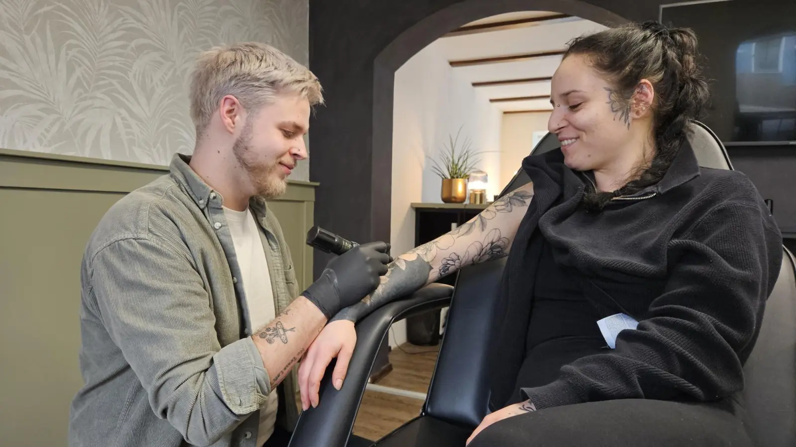 Lukas Günther (26) hat in Eschenbach direkt am Marienplatz in der Hausnummer 40 das Tattoo-Studio Botanica eröffnet. Seine Schwester Selina Günther lässt sich dort von ihm in mehreren Sitzungen den ganzen Arm tätowieren.  (Bild: Sonja Kaute)